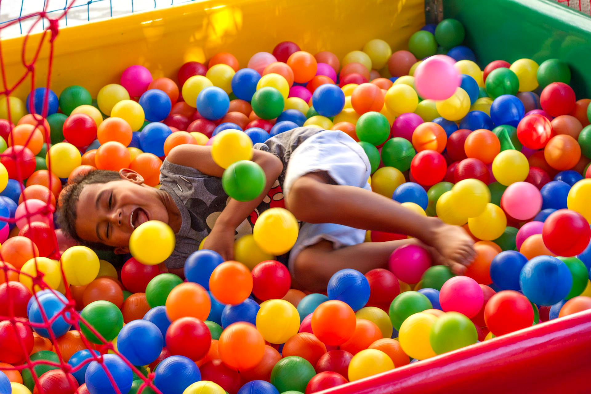 Kid playing in ball pit