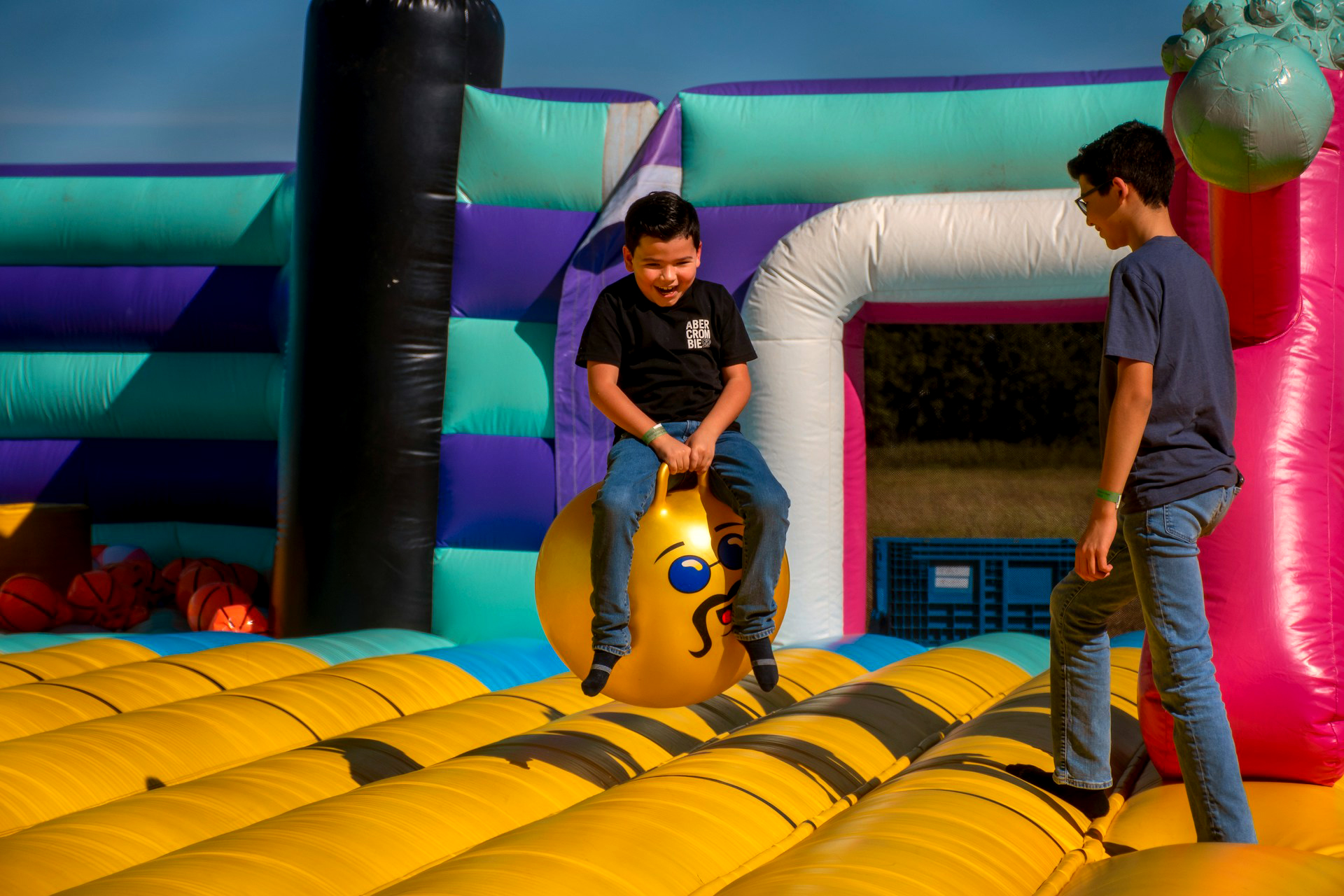 Two kids playing in bounce castle
